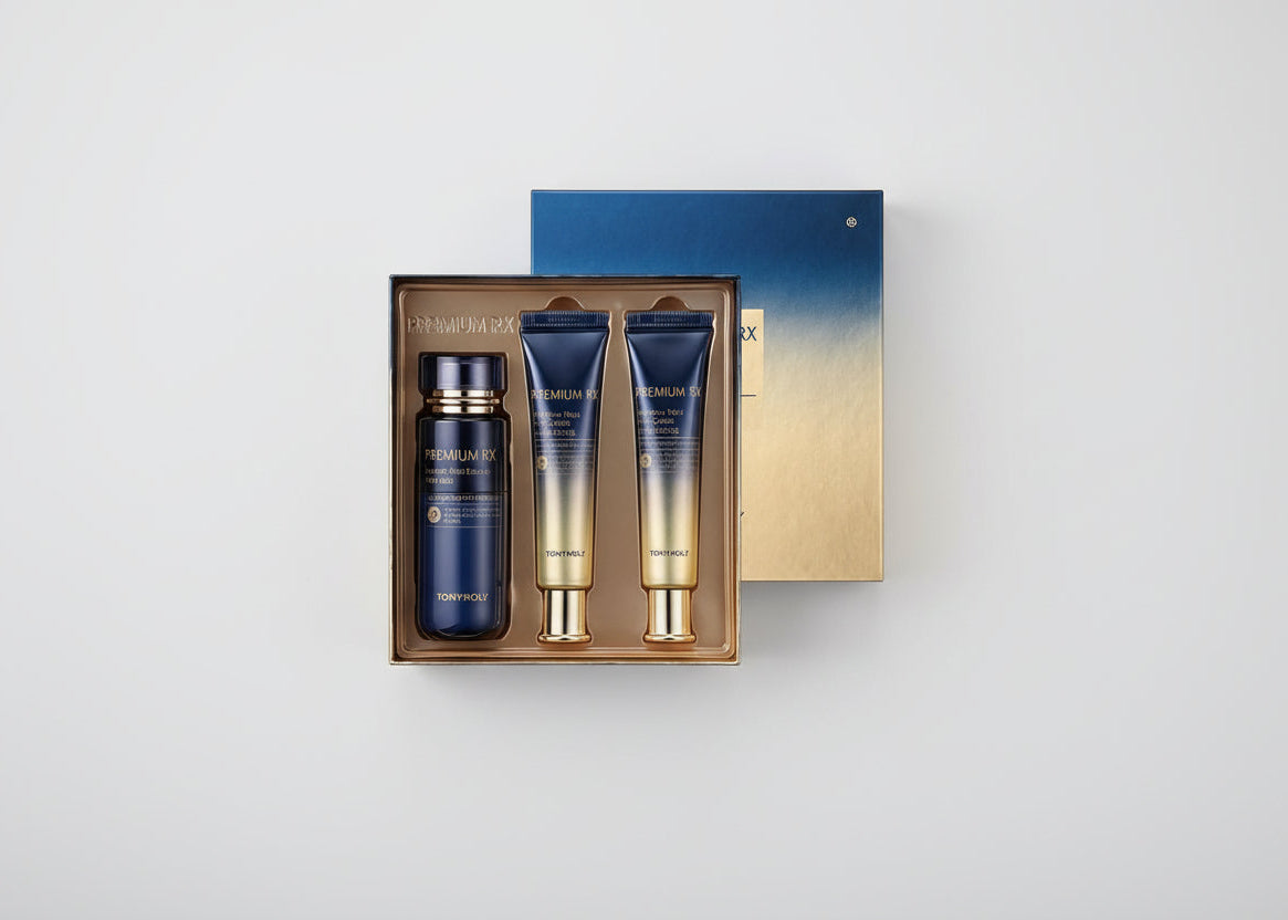 Skincare product set with blue and gold bottles in a box on a light gray background