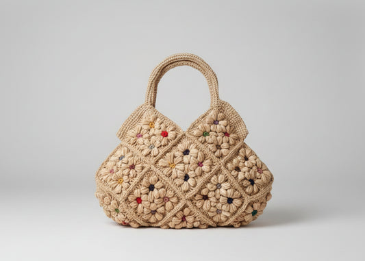 Crocheted handbag with floral pattern on a white surface