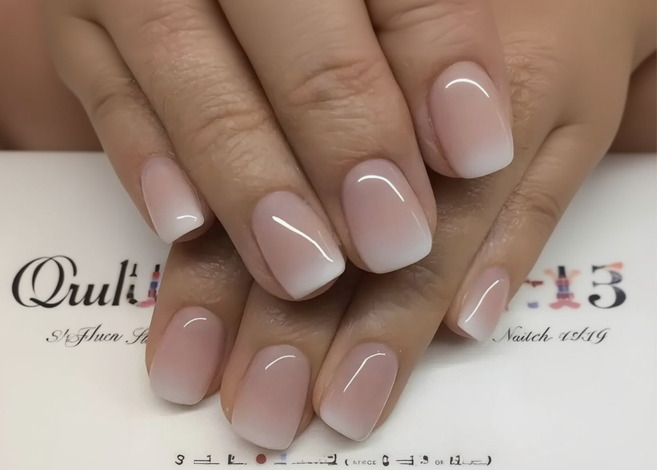 Close-up of hands with pink nail polish on a blurred background