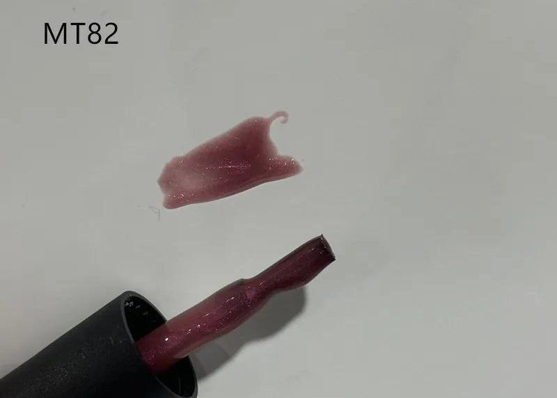 Lipstick with pink shade and black casing on a white background, labeled MT82.