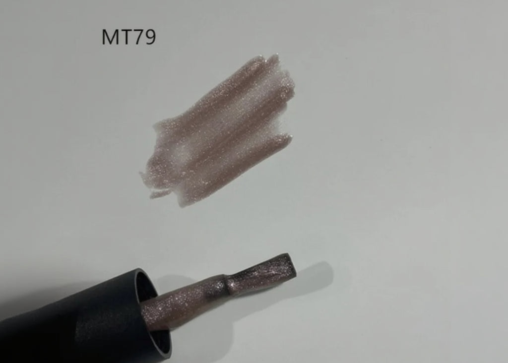 Nail polish with a glittery finish on a light gray background, labeled MT79.