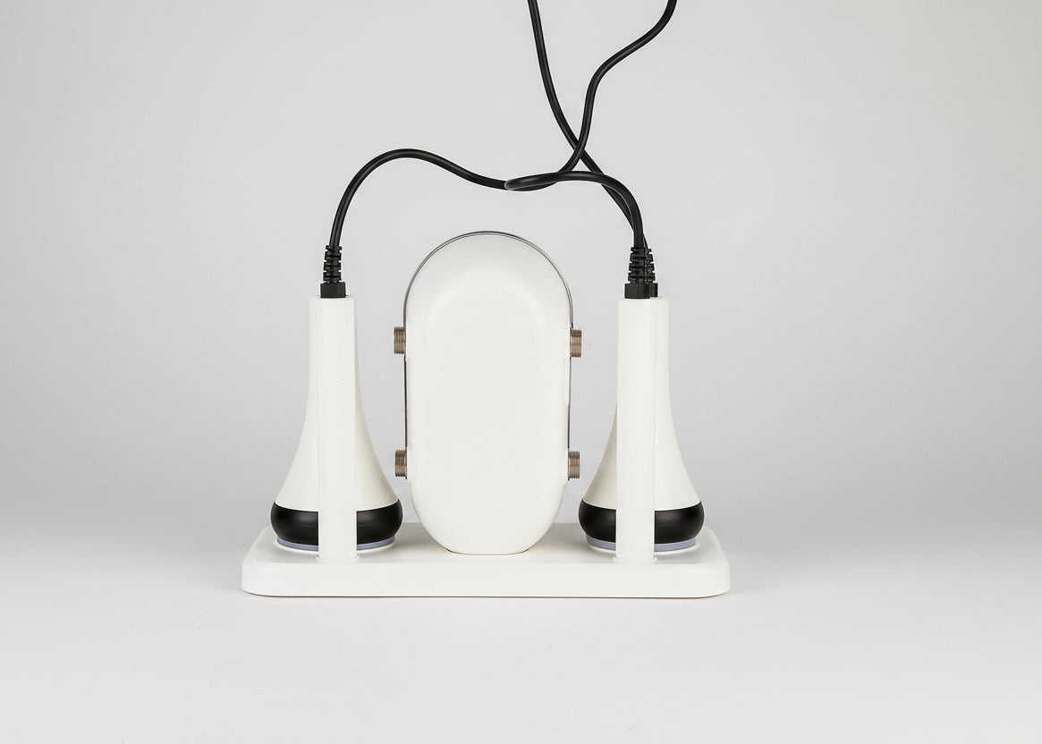 White electronic device with two black attachments on a white background