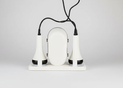 White electronic device with two black attachments on a white background