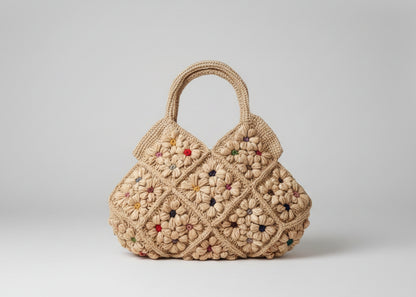 Crocheted handbag with floral pattern on a white surface