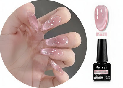 Hand with pink gel nail polish and MTSSII nail polish bottle on a white background