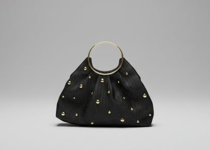 Black handbag with gold studs on a white background