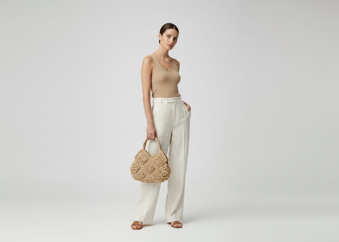 Crocheted bag with floral pattern on a white surface