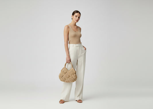 Crocheted bag with floral pattern on a white surface