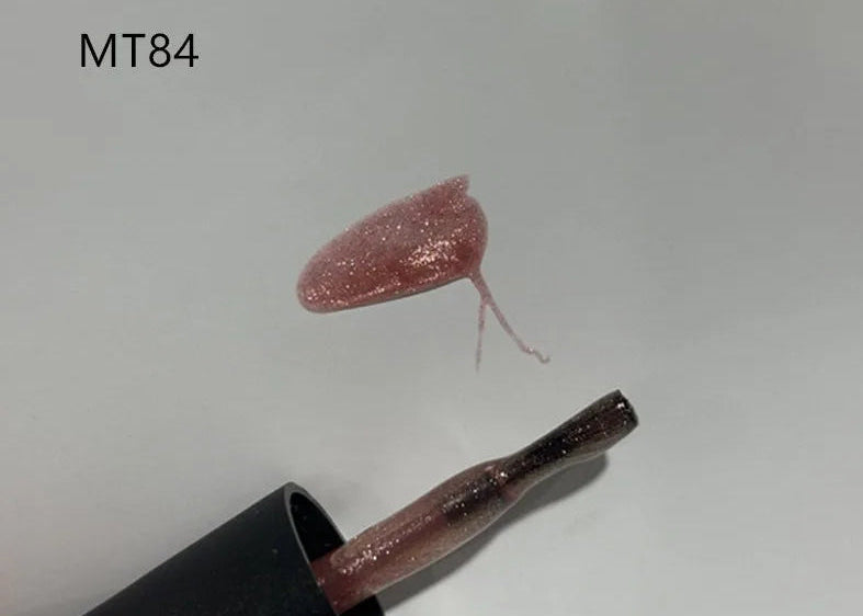 Lipstick with a pink glittery cap on a white background, labeled MT84.