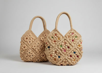 Two crocheted handbags with floral patterns on a light surface.