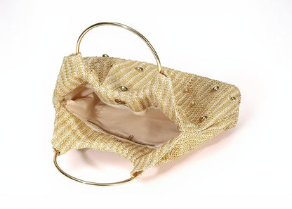 Gold clutch bag with a textured surface and gold handle on a white background