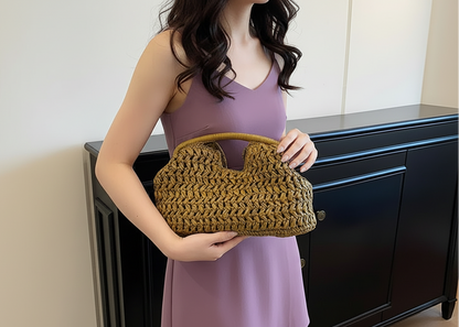 Person holding a mustard yellow woven handbag