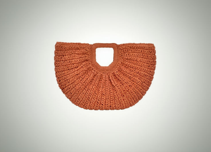 Orange woven handbag on a white background
