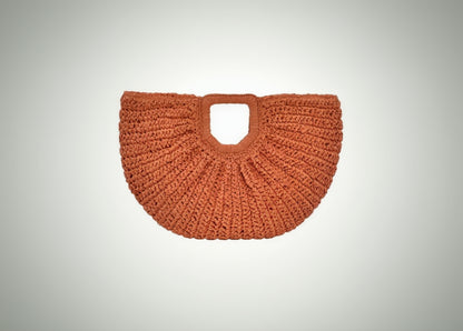 Orange woven handbag on a white background