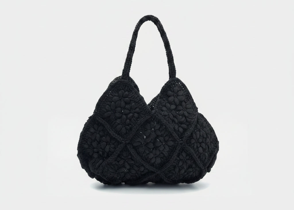 Black textured handbag on a white background