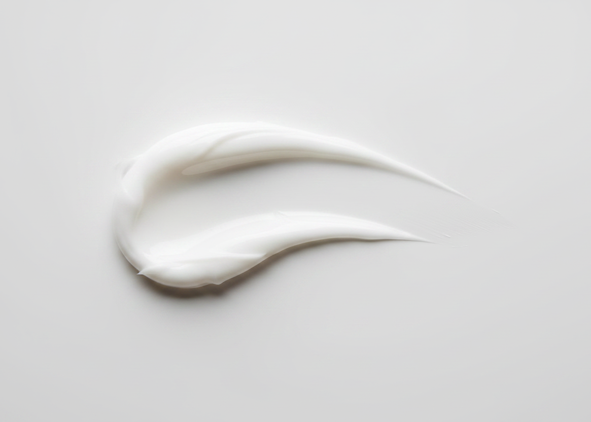 A thick, creamy white cosmetic smear on a light gray background with a beige banner at the bottom reading '#01 Pure'.
